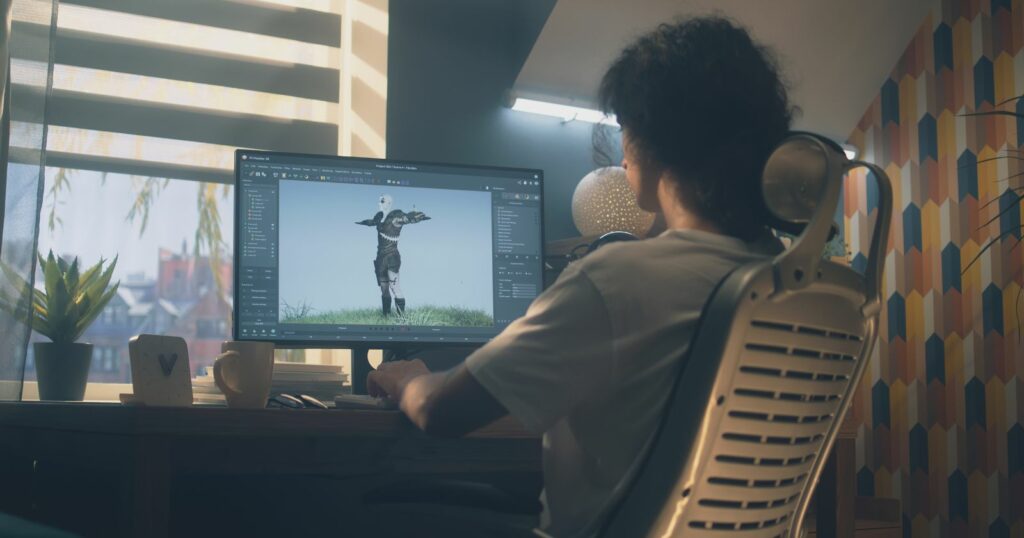Person at desk with computer screen for 3D online course.